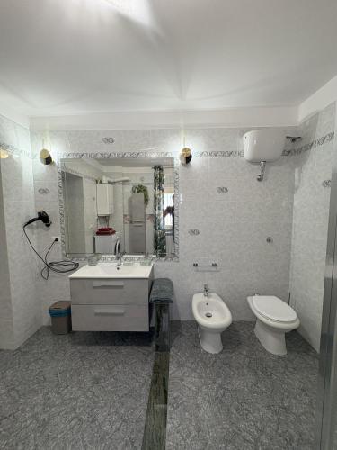 a bathroom with a sink and a toilet and a mirror at Sunderville Superior in Peschici