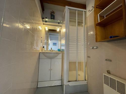 a small bathroom with a sink and a shower at T2 avec Mezzanine, Piscine, Parking, Animaux admis - FR-1-379-131 in Vieux-Boucau-les-Bains