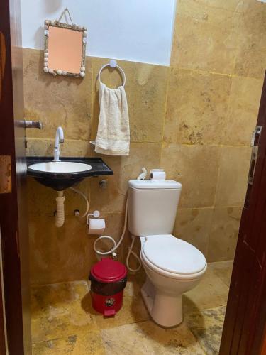 a bathroom with a toilet and a sink at Casa Girasol in Trairi
