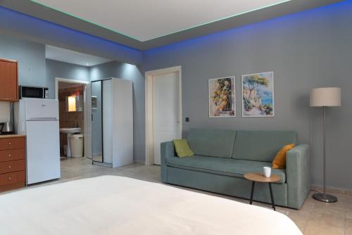 a living room with a couch and a kitchen at Stay & Smile apartments in Kallithea Halkidikis