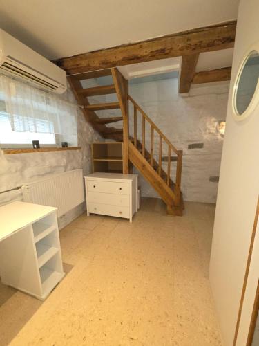 a room with a staircase and a white dresser at Suur-Ameerika Apartment in Tallinn