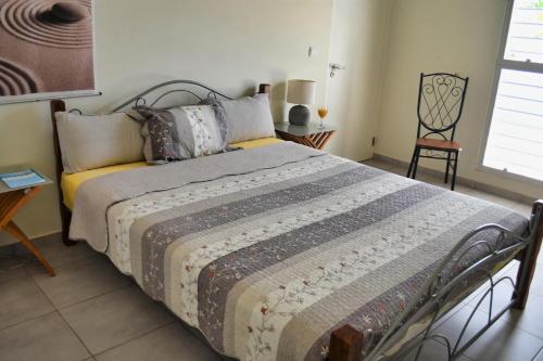 a bedroom with a bed and a table and a chair at Don Genaro Apartments in Barber