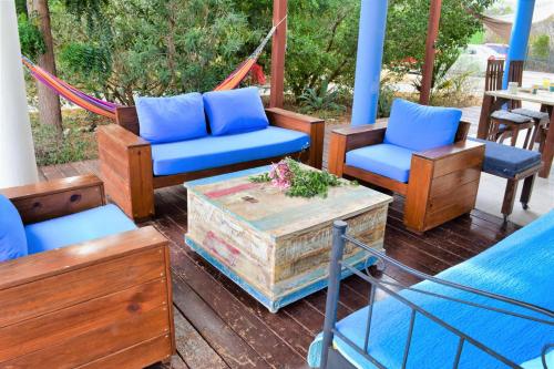 a porch with chairs and a table and a hammock at Don Genaro Apartments in Barber
