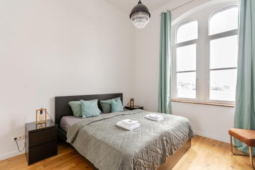 a bedroom with a bed and a large window at Wohnen wie im Schloss - Alter Bahnhof von Kruft in Kruft