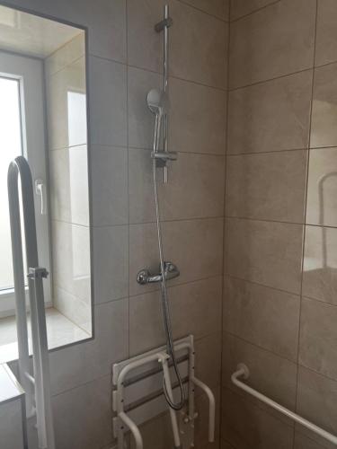 a shower in a bathroom with a glass door at Lawendowa Willa in Kaczki Średnie