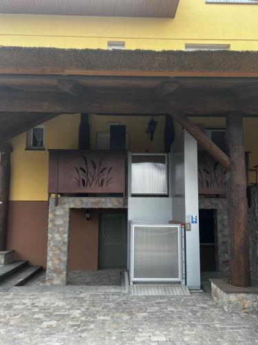 a building with two garage doors and a building at Lawendowa Willa in Kaczki Średnie