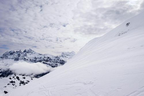 a snow covered mountain with a person on a snow covered slope at Résidence Antarès - Avoriaz in Morzine