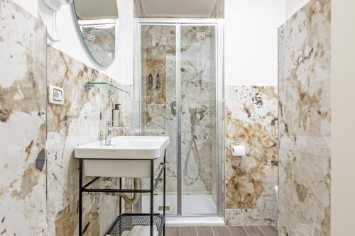 a bathroom with a sink and a shower at Maison dei Greci in Rome