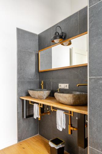 a bathroom with two sinks and a mirror at Wohnen wie im Schloss - Alter Bahnhof von Kruft in Kruft