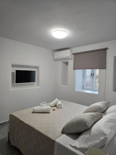 a bedroom with a bed with two pillows on it at Mystic Harmony in Mýkonos City