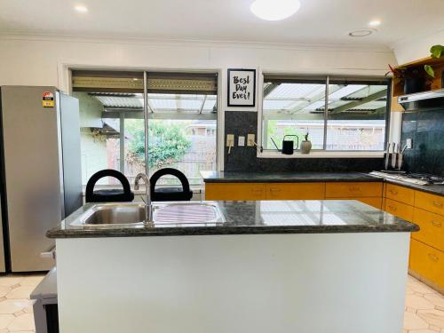 a kitchen with a sink and a counter top at D142 Sunshine Designed Living in Sunshine