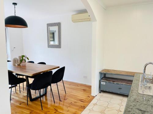 a kitchen and dining room with a table and chairs at D142 Sunshine Designed Living in Sunshine
