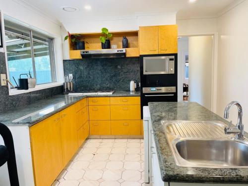 a kitchen with a sink and a counter top at D142 Sunshine Designed Living in Sunshine