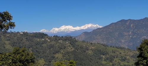 a mountain range with snow capped mountains in the background at Silent Echo Campsite in Māngwa