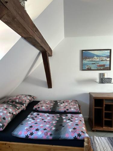 a bed sitting in a room with a staircase at Penzion Bluegrass in Český Krumlov