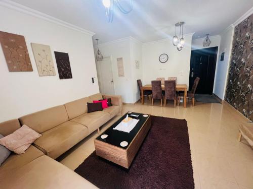 a living room with a couch and a table at Cozy Modern Comfort-2 Bed Escape at Madinaty in Madinaty