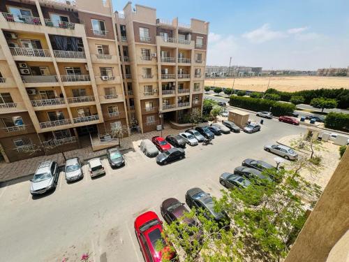 an aerial view of a parking lot in front of a building at Cozy Modern Comfort-2 Bed Escape at Madinaty in Madinaty