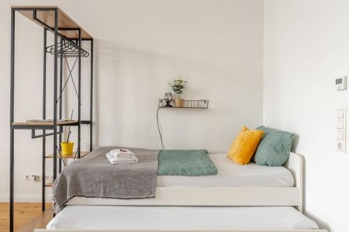 a white room with a white couch with colorful pillows at Wohnen wie im Schloss - Alter Bahnhof von Kruft in Kruft