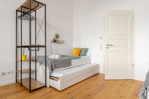 a bedroom with a bed and a book shelf at Wohnen wie im Schloss - Alter Bahnhof von Kruft in Kruft