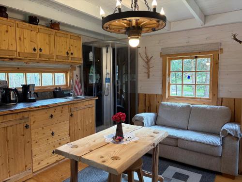 a kitchen and living room with a table and a couch at Reiu majake in Reiu