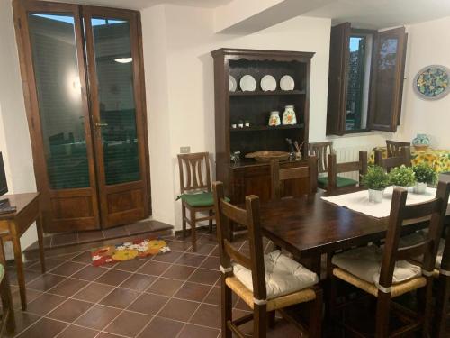 a dining room with a wooden table and chairs at Casa Maria Saturnia in Saturnia