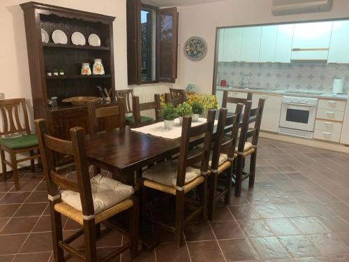 a kitchen with a wooden table and chairs at Casa Maria Saturnia in Saturnia