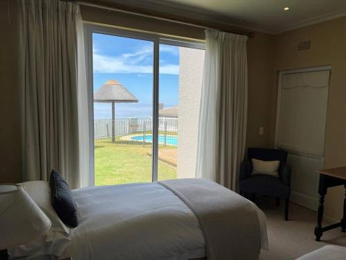 a hotel room with a bed and a large window at 3 Bedroom Villa in Pinnacle Point Estate in Mossel Bay