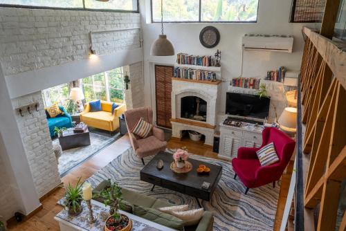 a living room filled with furniture and a fireplace at The Owls Nest Farm in Dharmsala