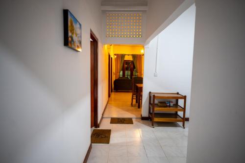 a hallway leading to a living room with a table at Carmel Crown Villa in Hatton