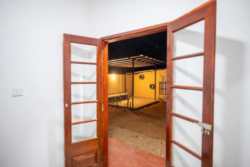 an open door to a room with a yellow wall at Carmel Crown Villa in Hatton