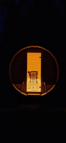 a wooden object is shown in a black background at Sosnowa Chata, Sauna in Jelenia Góra-Jagniątków