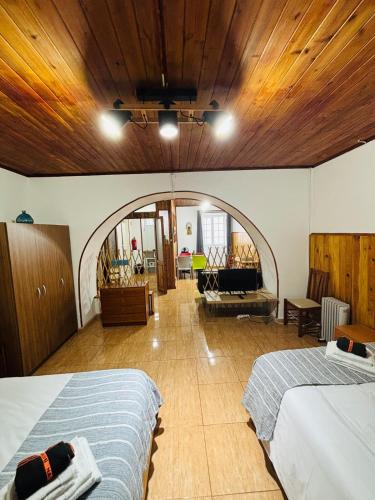a bedroom with two beds and a living room at Studio 58 - Casa Pamplona Serpa in Ponta Delgada