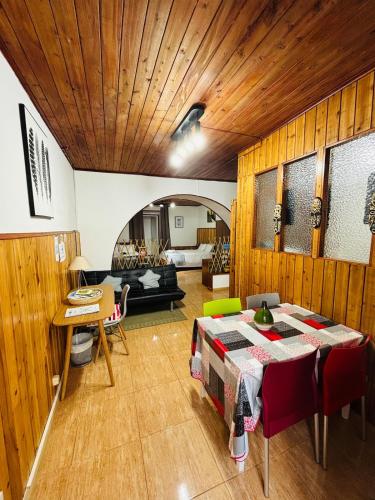 a living room with a table and a couch at Studio 58 - Casa Pamplona Serpa in Ponta Delgada