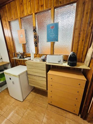 a room with a desk and a sink and a window at Studio 58 - Casa Pamplona Serpa in Ponta Delgada