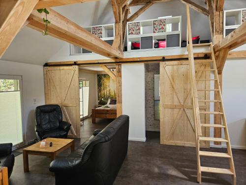 a room with a loft bed and a living room at Cottage am Michelsberg in Bad Münstereifel