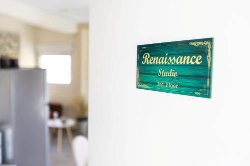 a green sign on a door in a room at Renaissance Studio- Rooftop, Views & Charm in Rethymno Town