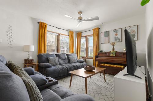 a living room with a couch and a flat screen tv at The Gilded Cottage Entire Home in Rockford