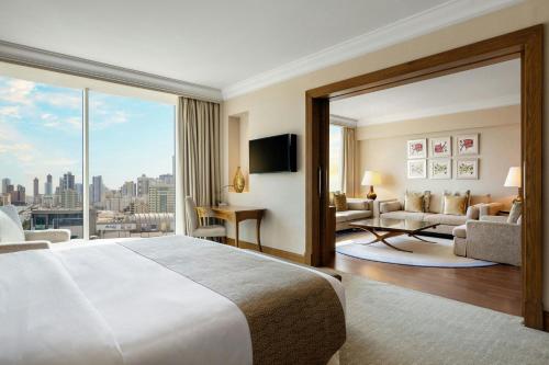 a hotel room with a large bed and a large window at Gulf Hotel Bahrain Convention and SPA in Manama