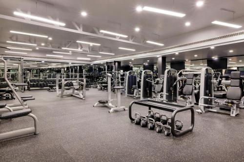 a gym with lots of treadmills and machines at Gulf Hotel Bahrain Convention and SPA in Manama