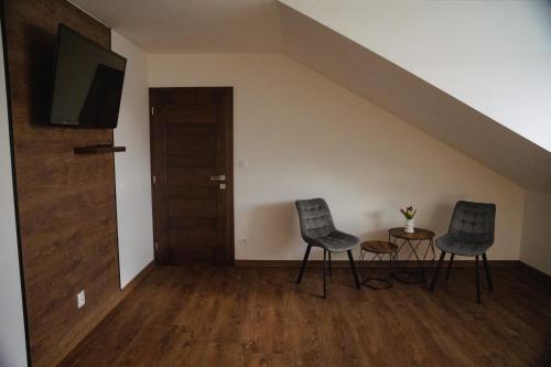 two chairs and a table with a tv in a room at Privat Agapi in Vrbov