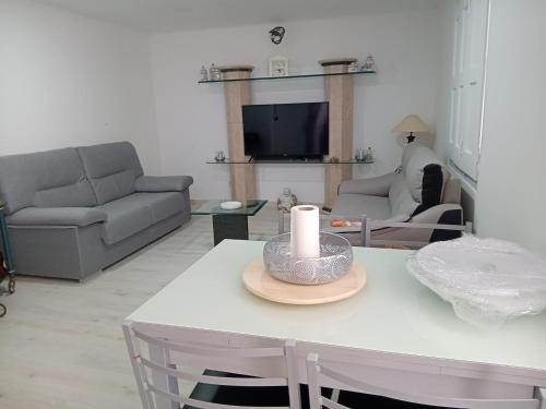 a living room with a table with a candle on it at Refúgio do Tejo in Tramagal