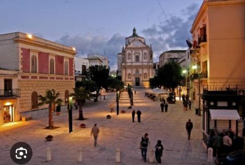 a group of people walking around a city street at Casa Viola - Central Apartment City & Sea in Alcamo