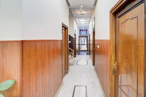 a hallway with wood paneling and a long aisle at Super Hotel O Krishna Nagar Chowk Near ONGC in Dehradun