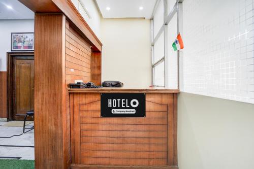 a wooden door with a hotel sign on it at Super Hotel O Krishna Nagar Chowk Near ONGC in Dehradun