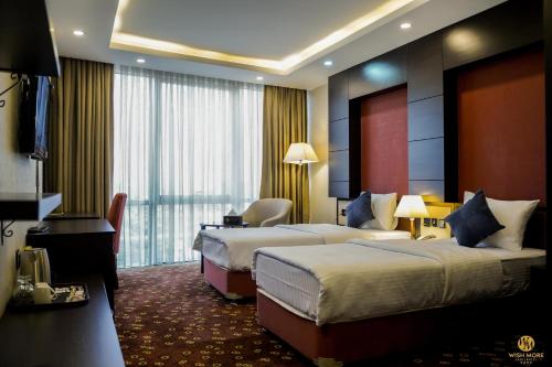 Ένα ή περισσότερα κρεβάτια σε δωμάτιο στο Wish More Hotel Erbil