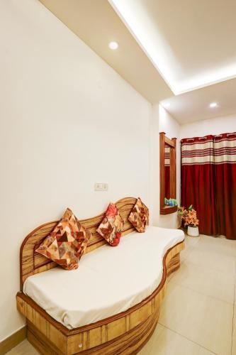 a bedroom with a wooden bed with pillows on it at Hindustan By Backpackers Heaven - Traveller's Choice Award 2025 Best of Best Winning Hotel in New Delhi
