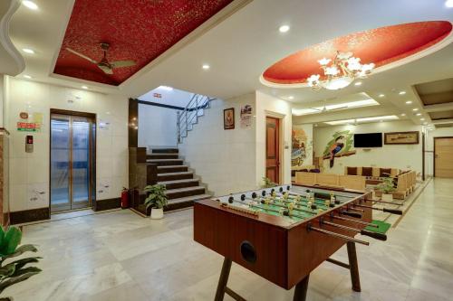 a room with a foosball table in the middle at Hindustan By Backpackers Heaven - Traveller's Choice Award 2025 Best of Best Winning Hotel in New Delhi