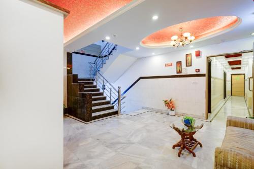 a living room with a staircase and a couch at Hindustan By Backpackers Heaven - Traveller's Choice Award 2025 Best of Best Winning Hotel in New Delhi