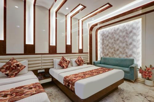 a bedroom with two beds and a blue chair at Hindustan By Backpackers Heaven - Traveller's Choice Award 2025 Best of Best Winning Hotel in New Delhi