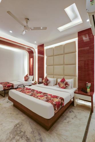 a bedroom with a large bed and a large window at Hindustan By Backpackers Heaven - Traveller's Choice Award 2025 Best of Best Winning Hotel in New Delhi